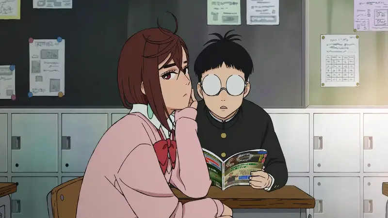 Momo Ayase rests her chin on her hand looking bored while Ken Okarun reads an occult magazine at their high school desk.