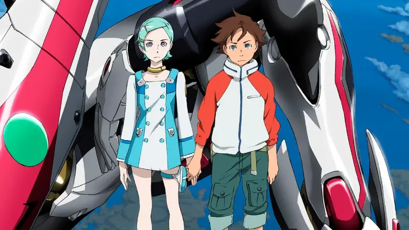 Eureka and Renton Thurston hold hands while standing in front of the Nirvash TypeZERO mecha against a bright blue sky.