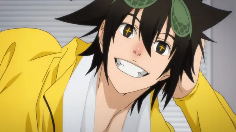 Jin Mori smiles brightly in his yellow jacket with his signature green sleeping mask resting on his head in The God of High School.