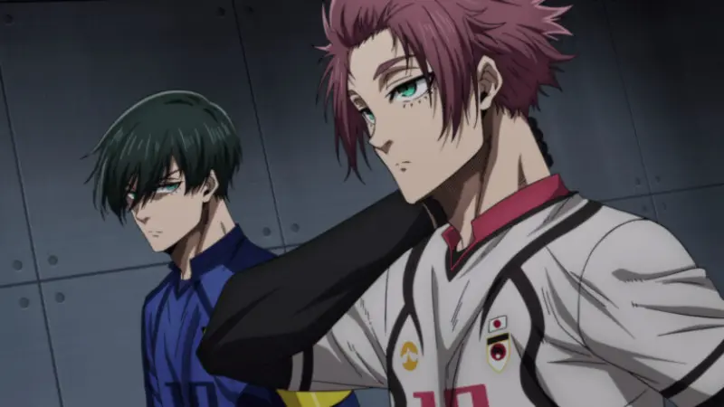 Rin Itoshi touches his neck while walking past his opponent and brother, Sae Itoshi, in their contrasting soccer uniforms before the big match.