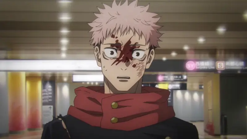 Yuji Itadori stands in a brightly lit subway station with a horrified expression and a severe bloody gash across his face in Jujutsu Kaisen.