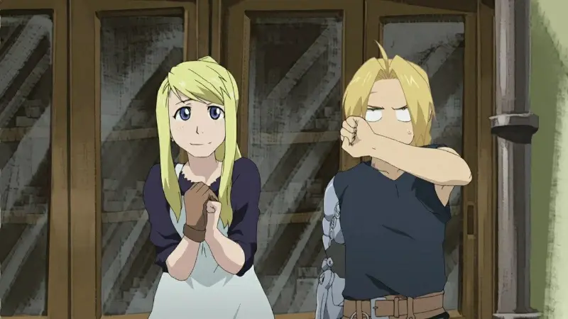 Winry smiling with clasped hands while Edward wipes his face with his automail arm in Fullmetal Alchemist: Brotherhood.