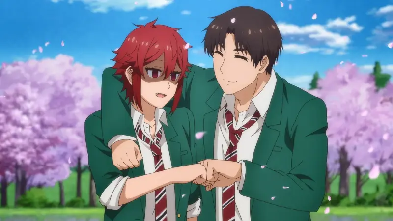 Tomo and Jun bumping fists while wearing green school uniforms under falling cherry blossoms in Tomo-chan Is a Girl!