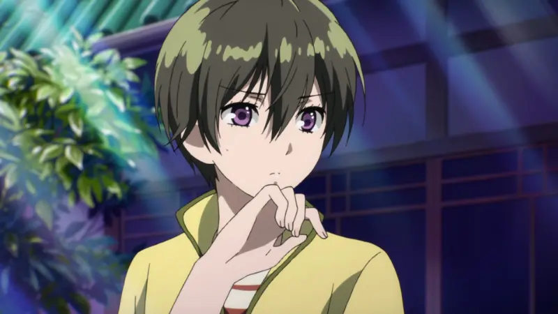 Ritsu Kawai stands thoughtfully with her hand near her chin under bright sunlight on a traditional wooden porch.