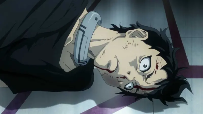 Ganta Igarashi lying on the floor wearing a metal neck collar after a brutal round in Deadman Wonderland.