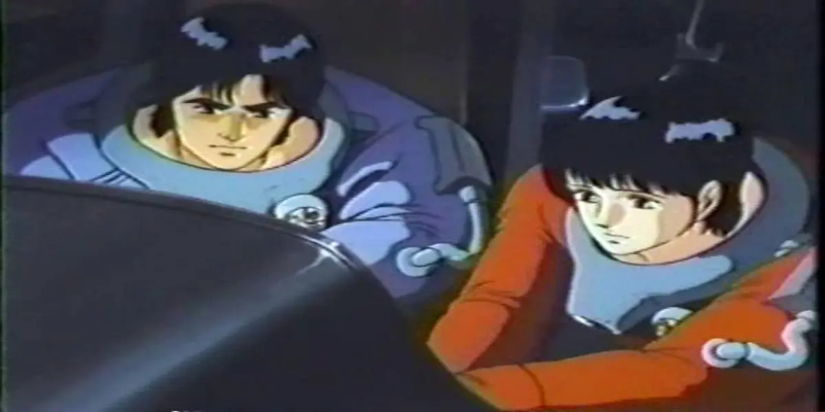Makoto and a crewmate wear bulky retro space suits while examining a dark console in the sci-fi anime Hell Target.