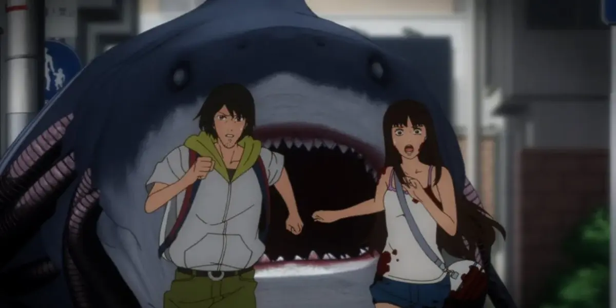 Tadashi and Kaori run in terror from a giant mechanical shark on the city streets in the anime Gyo: Tokyo Fish Attack.