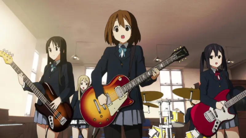 Yui Hirasawa singing and playing her electric guitar alongside the rest of the high school girls in the Light Music Club.