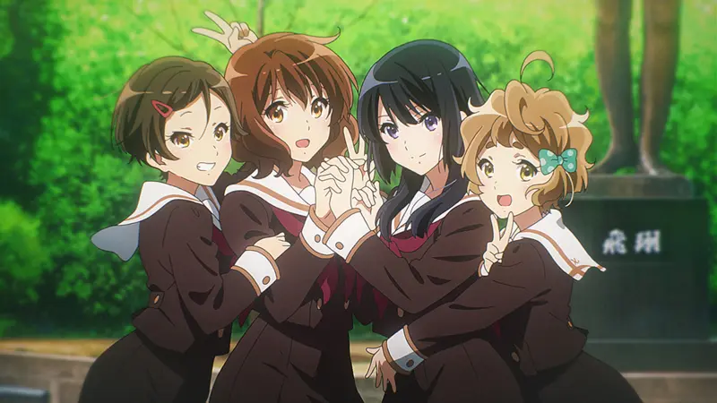 Kumiko Oumae and Reina Kousaka smiling and posing happily with their brass band friends in a green park setting, a vibrant scene from a contender for the best music anime.