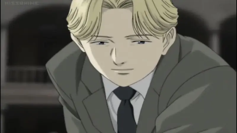 The terrifyingly manipulative criminal genius Johan Liebert smiles faintly in a grey suit in the psychological anime Monster.