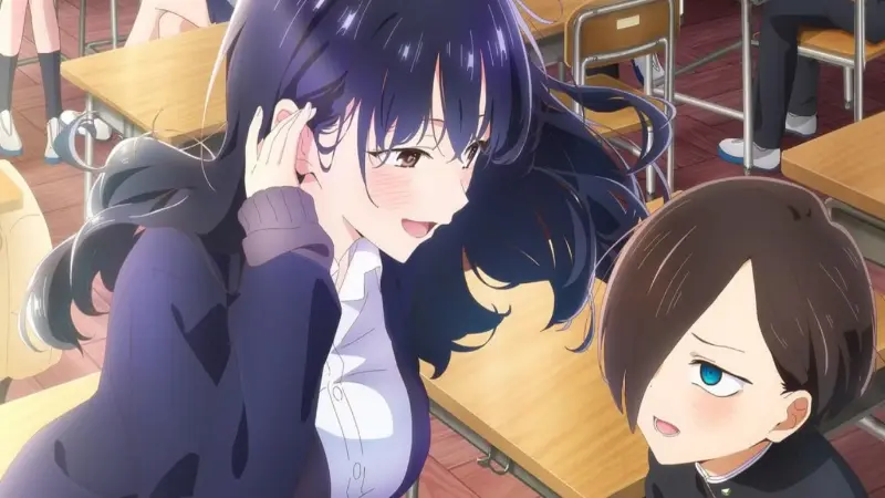Anna Yamada tucking her hair back and smiling down at a blushing Kyotaro Ichikawa at a school desk in The Dangers in My Heart.