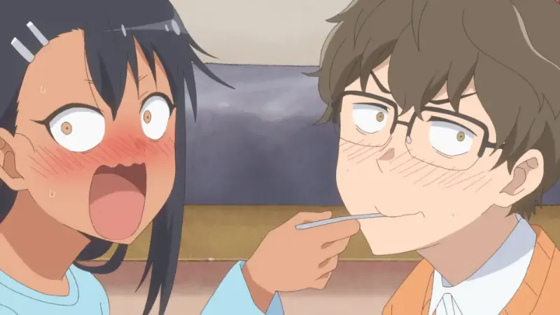 A blushing Hayase Nagatoro feeding Naoto Hachioji with a spoon as they both look completely shocked in Don't Toy With Me, Miss Nagatoro.