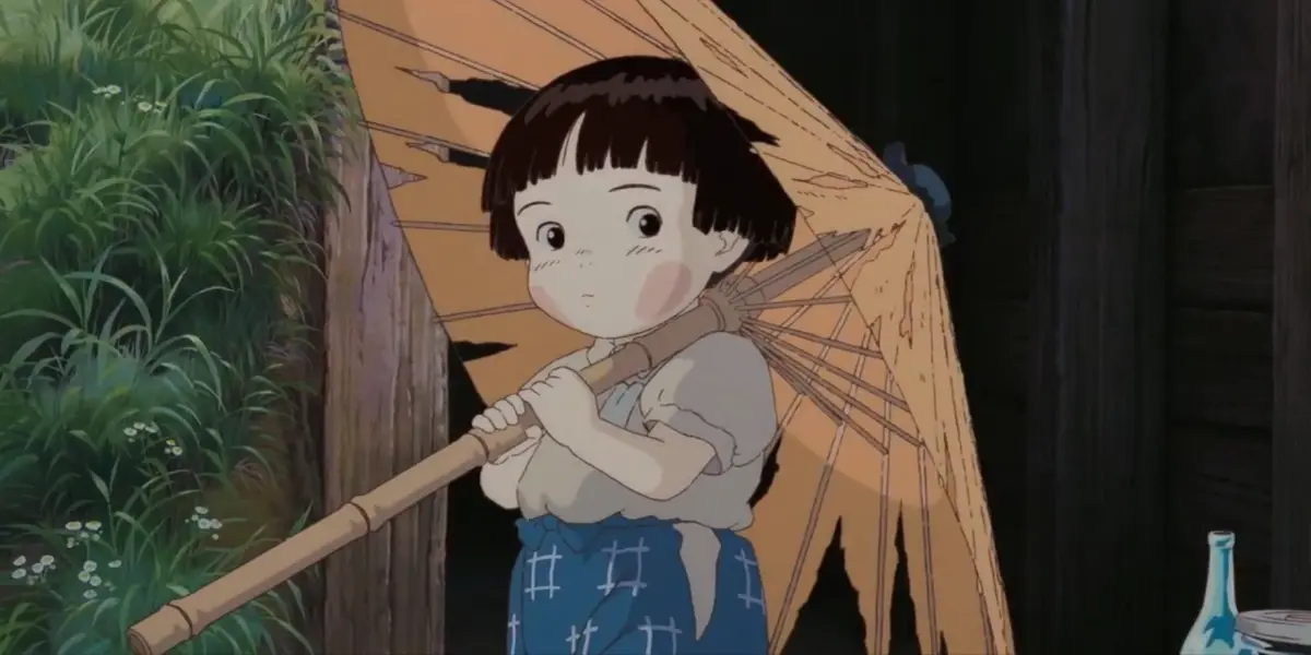 Setsuko holds a broken paper umbrella in a poignant scene from the anime Grave of the Fireflies.