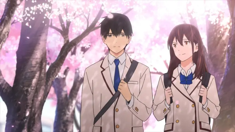 Haruki and Sakura walking side-by-side in their school uniforms under falling cherry blossoms in I Want to Eat Your Pancreas.