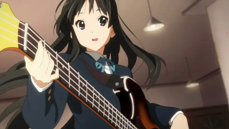 K-On! bassist Mio Akiyama playing her instrument with a surprised expression.