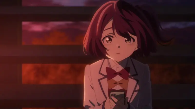 Makeine: Too Many Losing Heroines! character Chika Komari holding a phone nervously at dusk, wrapping up our list of the best dandere anime characters.