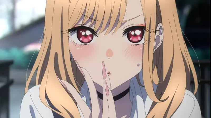 My Dress-Up Darling lead Marin Kitagawa striking a thoughtful pose with her striking pink eyes.