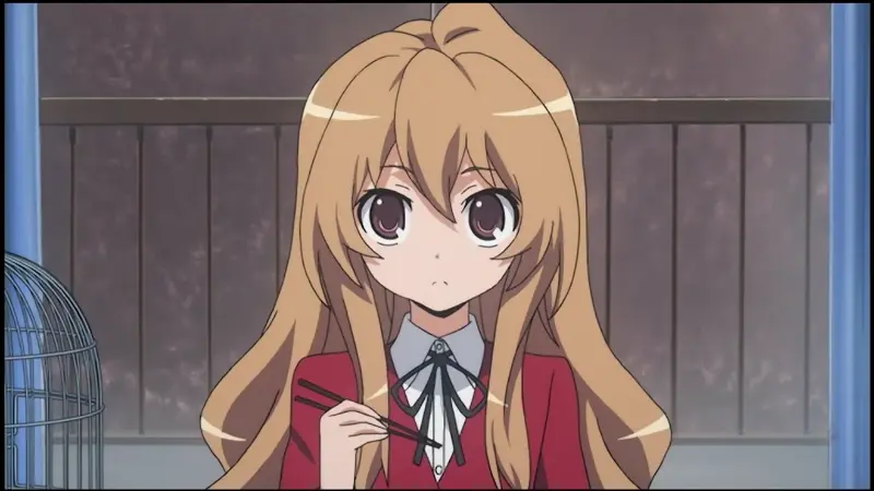Toradora! protagonist Taiga Aisaka staring blankly while holding a pair of chopsticks.