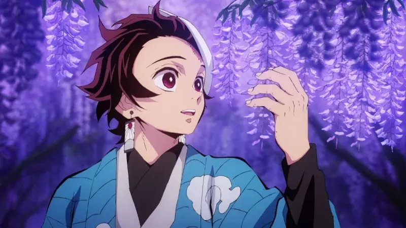 Tanjiro Kamado looking up at purple wisteria flowers in the dark fantasy anime Demon Slayer.