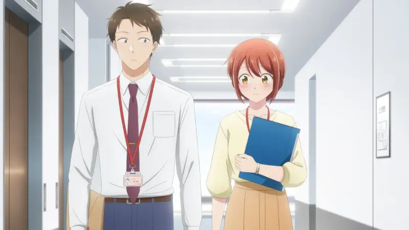 Yui Mitsuya blushes shyly while clutching a blue folder as she walks down a brightly lit office hallway next to Masugu Tateishi.