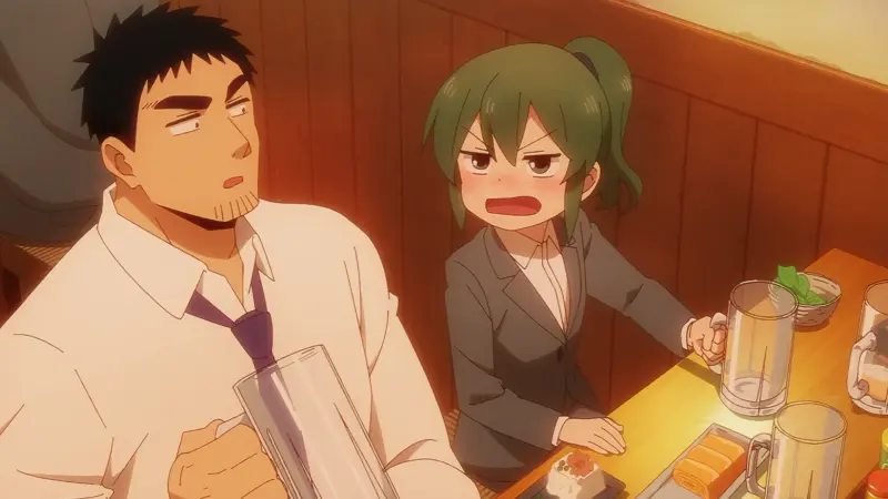 A flushed Futaba Igarashi yells playfully at her towering coworker Harumi Takeda while sitting at a wooden table with beer mugs.